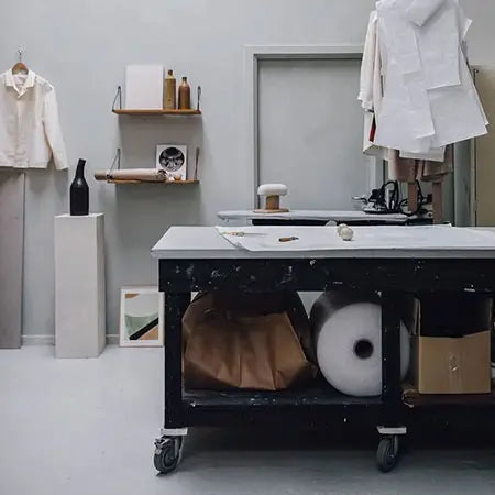 Workshop or studio space with a table, shelves, and various items.